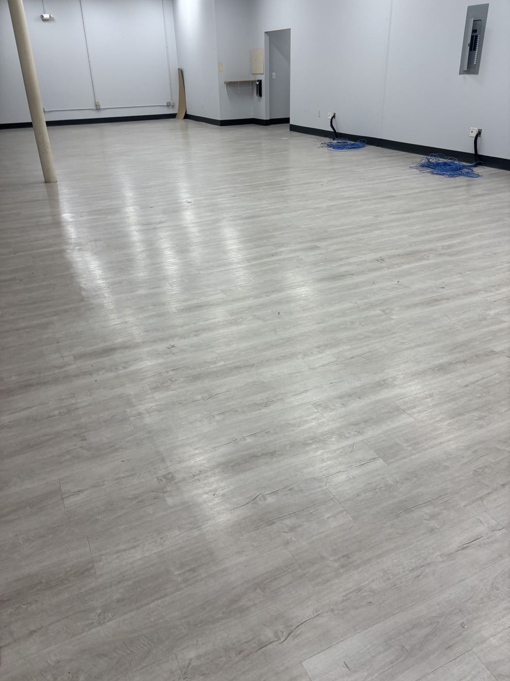 Clean, freshly mopped office floor in an empty commercial space